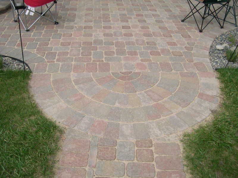 Cut Pavers for Circular Patterns in Block Patio by Sheridan Lawn and Landscaping, LLC